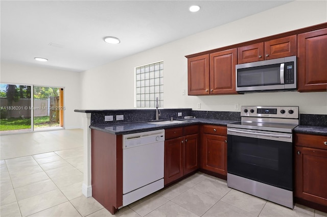 798 Quartz Ter, Palm Beach, FL 33413 - kitchen with stainless steel appliances, light tile patterned floors, a peninsula, and recessed lighting