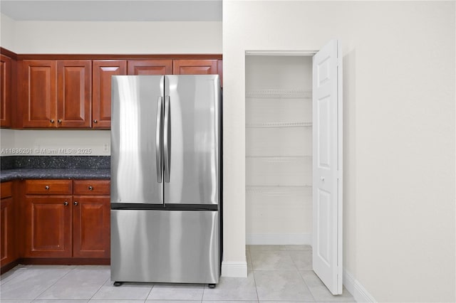 798 Quartz Ter, Palm Beach, FL 33413 - kitchen with freestanding refrigerator and light tile patterned flooring