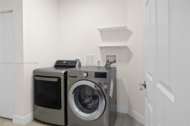 798 Quartz Ter, Palm Beach, FL 33413 - laundry area featuring washer and dryer and light tile patterned flooring