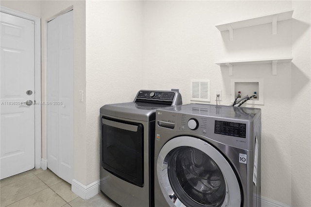 798 Quartz Ter, Palm Beach, FL 33413 - laundry room featuring separate washer and dryer and light tile patterned floors