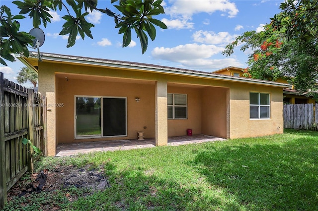798 Quartz Ter, Palm Beach, FL 33413 - rear view of house with stucco siding and a patio