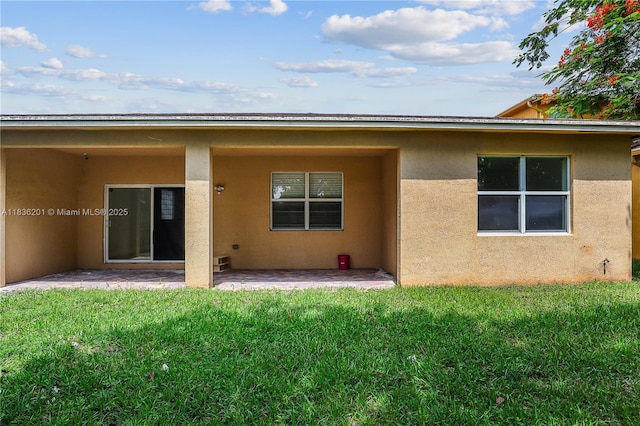 798 Quartz Ter, Palm Beach, FL 33413 - back of property with a patio, stucco siding, and a lawn