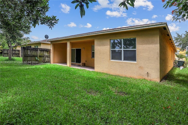 798 Quartz Ter, Palm Beach, FL 33413 - rear view of house with stucco siding and a patio