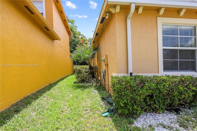 798 Quartz Ter, Palm Beach, FL 33413 - view of side of home with stucco siding and a yard