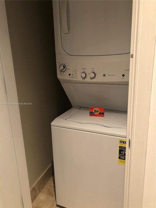 1435 Brickell Ave Unit 3106, Miami, FL 33131 - washroom featuring stacked washer / drying machine and light tile patterned floors