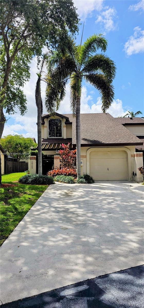 10194 SW 137th Ct Unit 10194, Miami, FL 33186 - view of front of house with stucco siding, an attached garage, and driveway