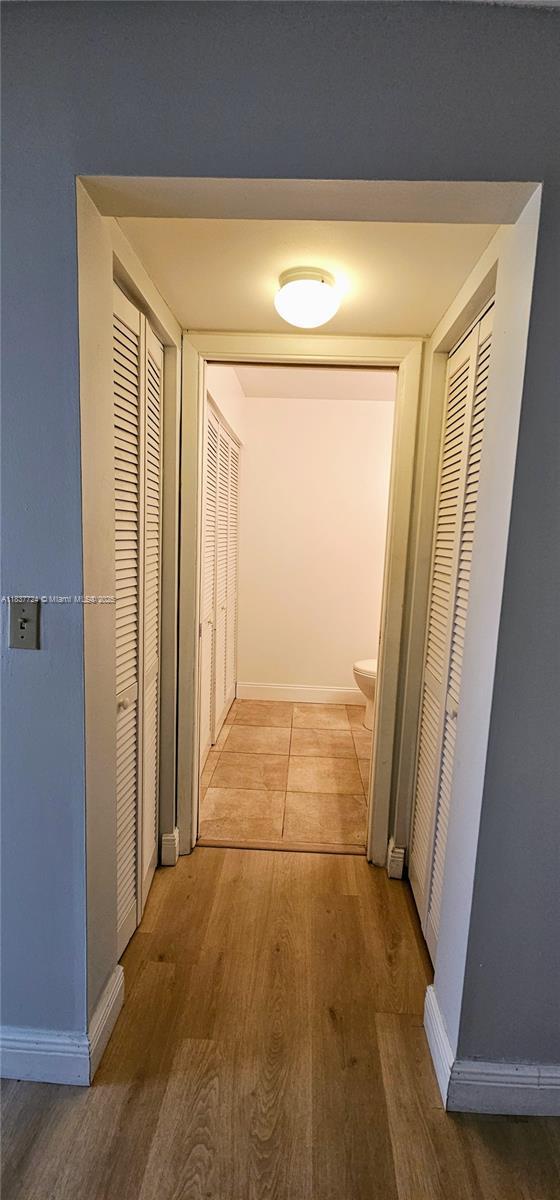 10194 SW 137th Ct Unit 10194, Miami, FL 33186 - hall featuring light wood-style flooring and baseboards