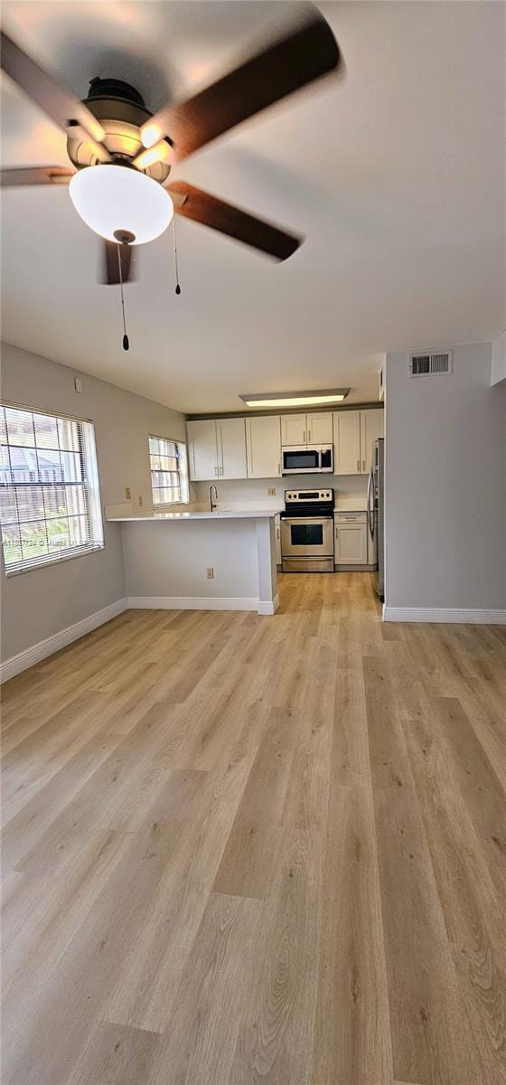 10194 SW 137th Ct Unit 10194, Miami, FL 33186 - unfurnished living room with light wood-type flooring and ceiling fan