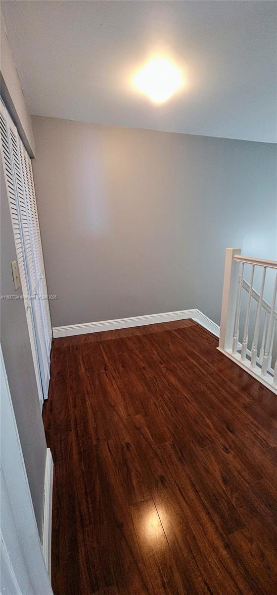 10194 SW 137th Ct Unit 10194, Miami, FL 33186 - unfurnished bedroom featuring dark wood-style flooring and a closet