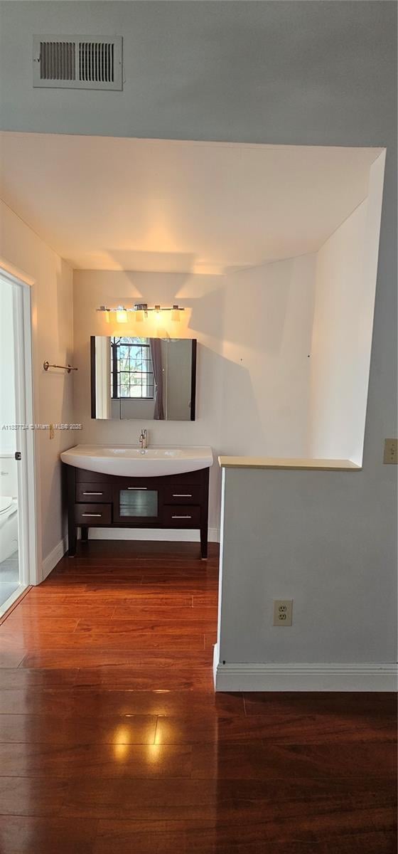 10194 SW 137th Ct Unit 10194, Miami, FL 33186 - kitchen featuring dark wood-style floors, dark brown cabinets, and light countertops