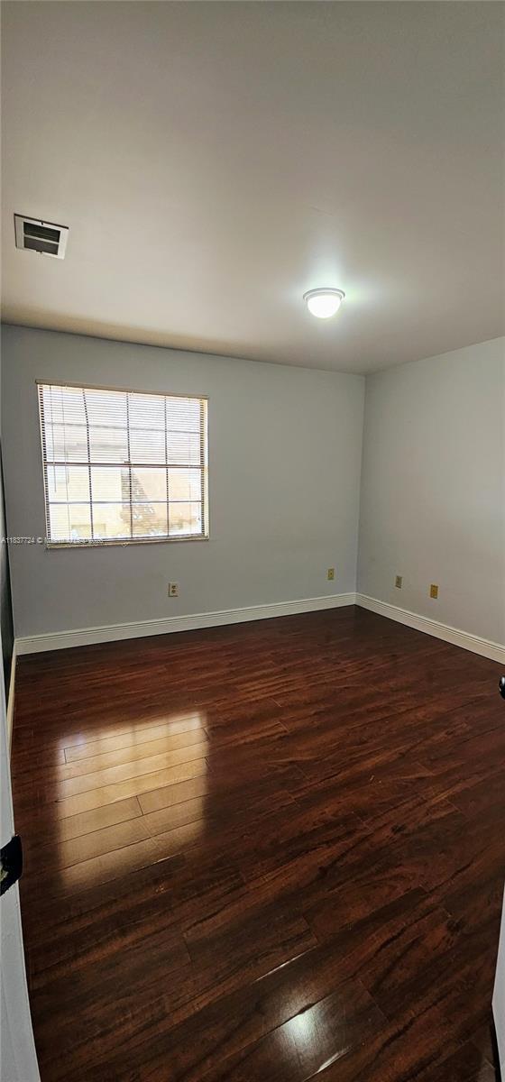 10194 SW 137th Ct Unit 10194, Miami, FL 33186 - unfurnished room with dark wood-style floors and baseboards
