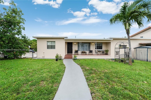 190 E 16th St, Hialeah, FL 33010 - single story home featuring stucco siding, a front yard, and a porch