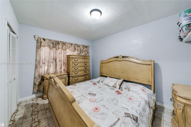 190 E 16th St, Hialeah, FL 33010 - bedroom featuring a textured ceiling and a closet