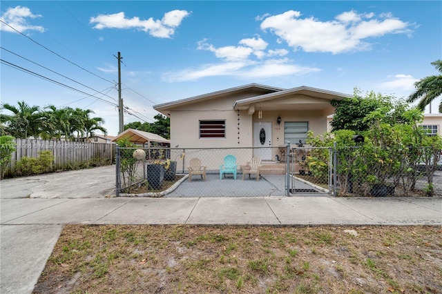 190 E 16th St, Hialeah, FL 33010 - view of front of house with a gate, a fenced front yard, and stucco siding
