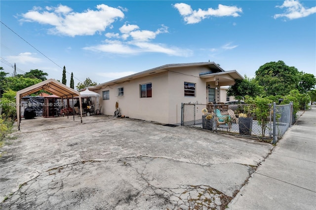 190 E 16th St, Hialeah, FL 33010 - view of property exterior featuring stucco siding, a carport, and driveway