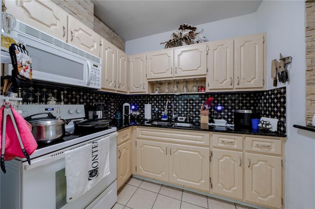 190 E 16th St, Hialeah, FL 33010 - kitchen with white appliances, light tile patterned floors, decorative backsplash, open shelves, and dark stone counters