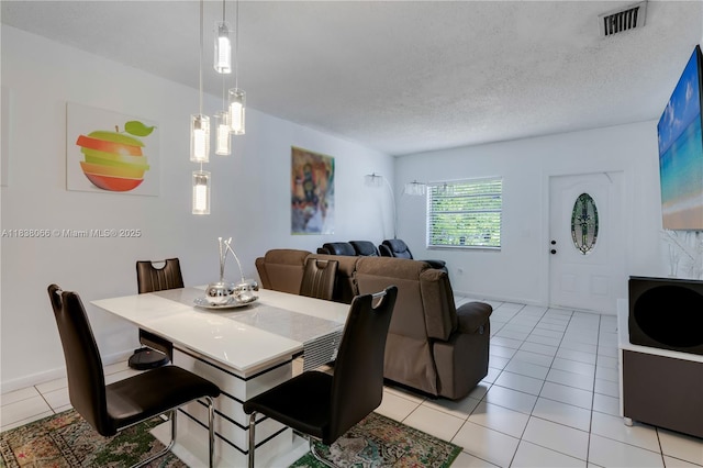 190 E 16th St, Hialeah, FL 33010 - dining room with light tile patterned flooring and a textured ceiling