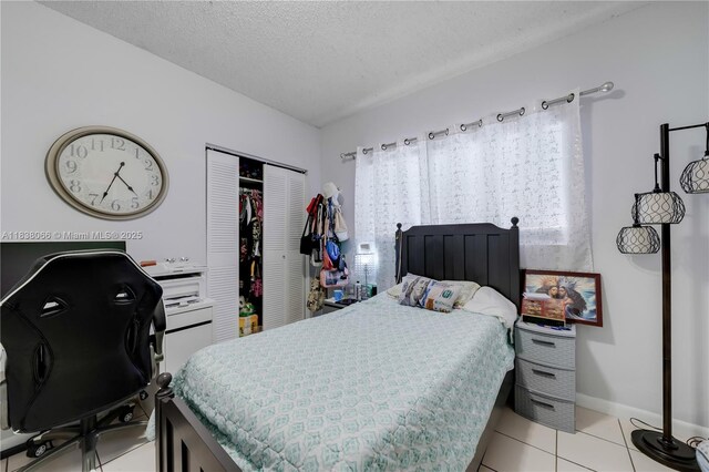 190 E 16th St, Hialeah, FL 33010 - bedroom featuring a closet, a textured ceiling, a desk, and light tile patterned floors