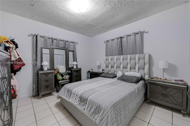190 E 16th St, Hialeah, FL 33010 - bedroom with a textured ceiling and light tile patterned flooring
