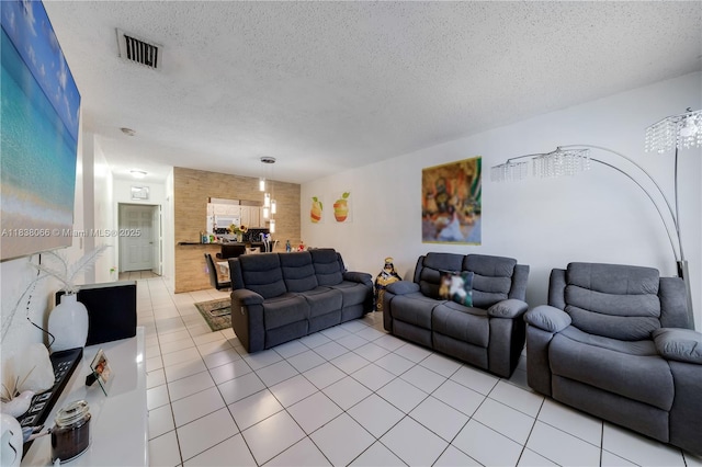 190 E 16th St, Hialeah, FL 33010 - living area with light tile patterned floors and a textured ceiling