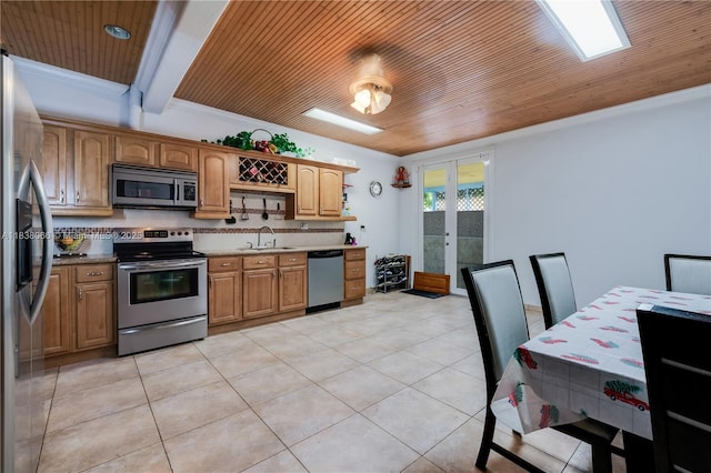 190 E 16th St, Hialeah, FL 33010 - kitchen featuring stainless steel appliances, wooden ceiling, french doors, light tile patterned floors, and ornamental molding
