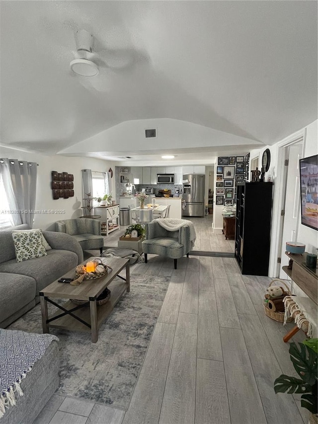 291 NW 95th St, Miami, FL 33150 - living area with light wood finished floors, lofted ceiling, and a ceiling fan