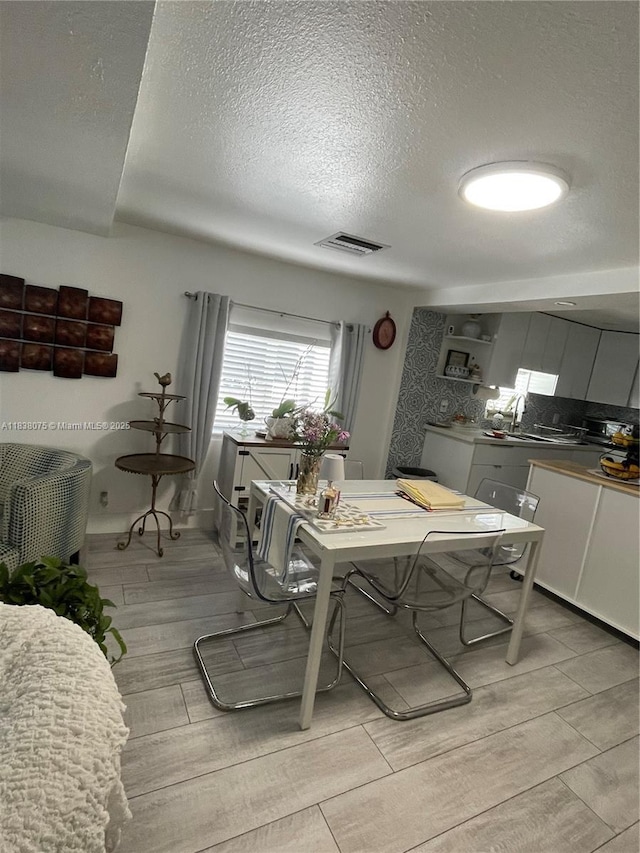 291 NW 95th St, Miami, FL 33150 - dining space with a textured ceiling and wood finish floors