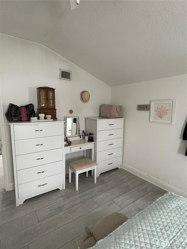 291 NW 95th St, Miami, FL 33150 - bedroom with vaulted ceiling, dark wood-style floors, and a textured ceiling