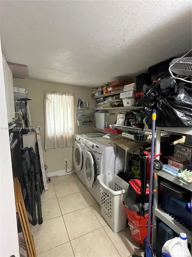 291 NW 95th St, Miami, FL 33150 - laundry room featuring washer and clothes dryer, light tile patterned floors, and a textured ceiling