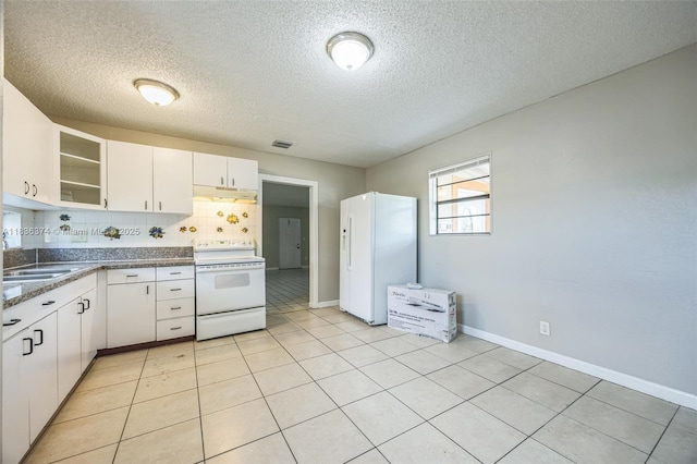 1160 NW 47th Ave, Lauderhill, FL 33313 - kitchen with white appliances, white cabinetry, a textured ceiling, backsplash, and glass insert cabinets