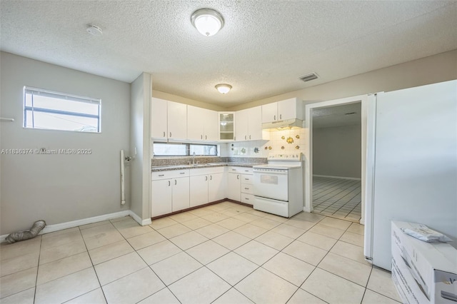 1160 NW 47th Ave, Lauderhill, FL 33313 - kitchen featuring white appliances, white cabinets, a textured ceiling, tasteful backsplash, and under cabinet range hood