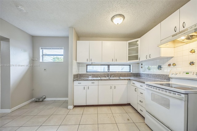 1160 NW 47th Ave, Lauderhill, FL 33313 - kitchen with white electric range oven, under cabinet range hood, tasteful backsplash, white cabinets, and dark countertops