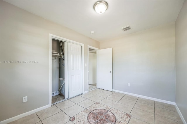 1160 NW 47th Ave, Lauderhill, FL 33313 - unfurnished bedroom featuring a closet and light tile patterned floors