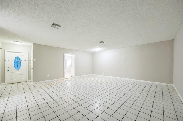 1160 NW 47th Ave, Lauderhill, FL 33313 - tiled empty room with baseboards and a textured ceiling