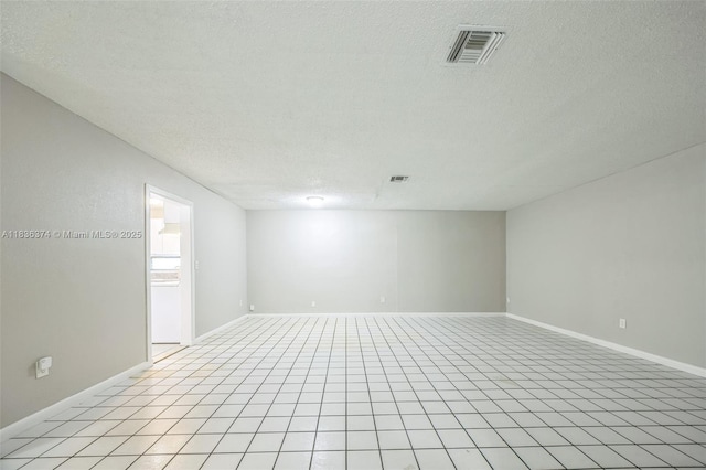 1160 NW 47th Ave, Lauderhill, FL 33313 - empty room featuring a textured ceiling and light tile patterned floors