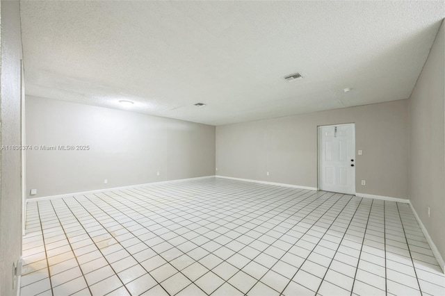 1160 NW 47th Ave, Lauderhill, FL 33313 - empty room featuring a textured ceiling and light tile patterned flooring