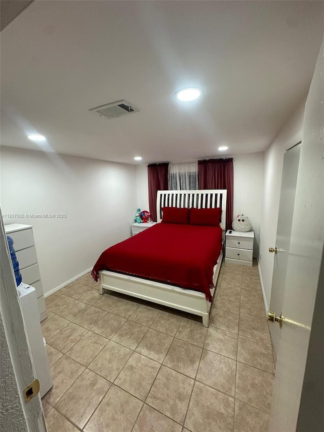 bedroom with recessed lighting and light tile patterned flooring