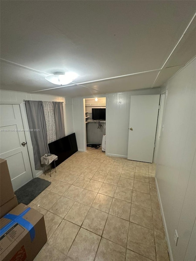 finished basement with light tile patterned floors