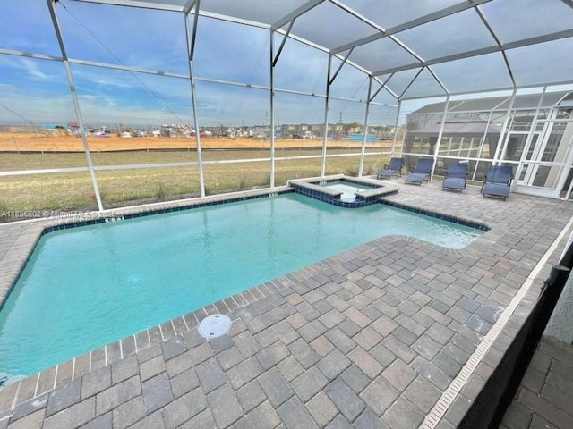 9338 Sommerset Hls, Kissimmee, FL 33896 - view of swimming pool with a patio area, glass enclosure, and a pool with connected hot tub
