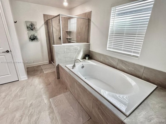 9338 Sommerset Hls, Kissimmee, FL 33896 - full bathroom featuring a shower stall, a bath, and healthy amount of natural light