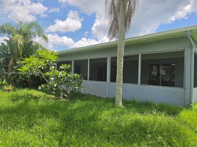 1744 SE Berkshire Blvd, Port St Lucie, FL 34952 - view of home's exterior featuring stucco siding and a sunroom