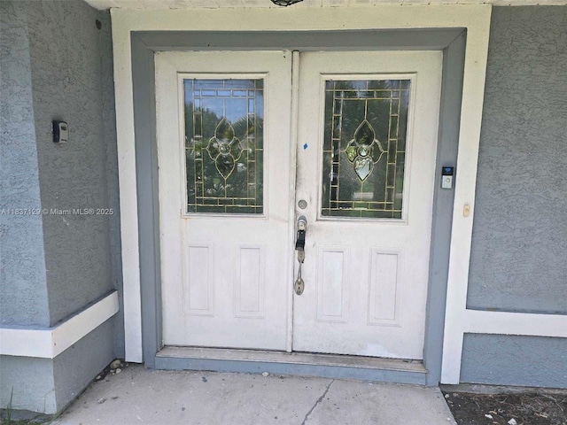 1744 SE Berkshire Blvd, Port St Lucie, FL 34952 - doorway to property featuring stucco siding