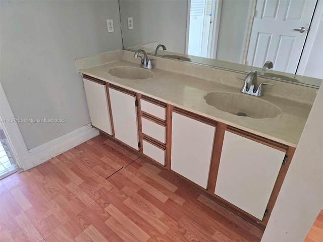1744 SE Berkshire Blvd, Port St Lucie, FL 34952 - bathroom with double vanity and wood finished floors