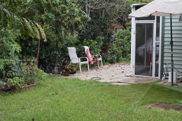 256 Broward Ave, Green Acres, FL 33463 - view of grassy yard featuring a patio