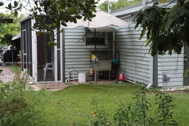 256 Broward Ave, Green Acres, FL 33463 - rear view of house with a lawn