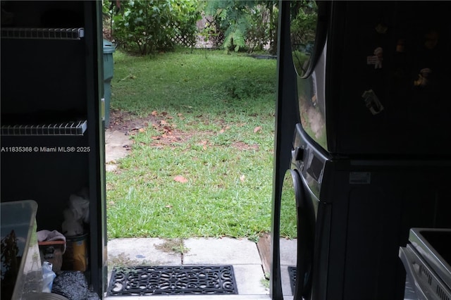 256 Broward Ave, Green Acres, FL 33463 - entryway featuring stacked washer / drying machine