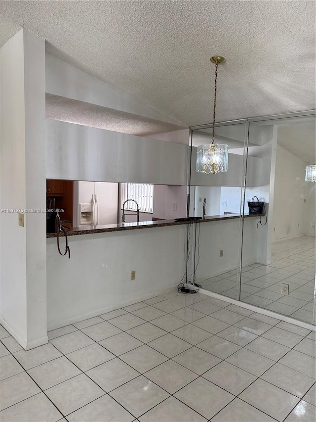 18240 Mediterranean Blvd Unit 5-11, Hialeah, FL 33015 - unfurnished room featuring a chandelier, a textured ceiling, and light tile patterned floors