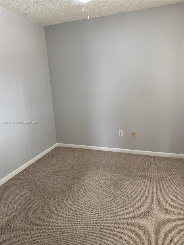 18240 Mediterranean Blvd Unit 5-11, Hialeah, FL 33015 - carpeted spare room with baseboards and a textured ceiling