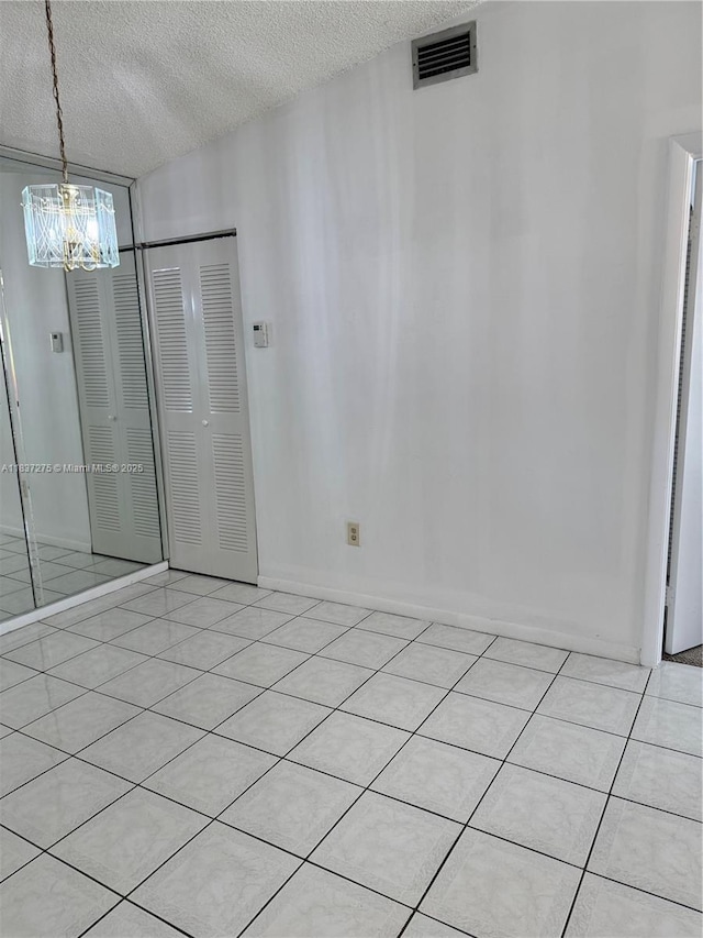 18240 Mediterranean Blvd Unit 5-11, Hialeah, FL 33015 - empty room featuring a chandelier and a textured ceiling
