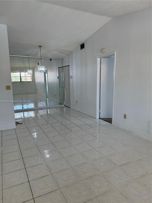 18240 Mediterranean Blvd Unit 5-11, Hialeah, FL 33015 - empty room with a textured ceiling and light tile patterned floors
